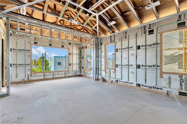 misc room featuring concrete flooring and vaulted ceiling