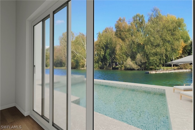 doorway featuring wood-type flooring and a water view