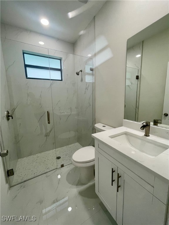 bathroom with walk in shower, vanity, and toilet