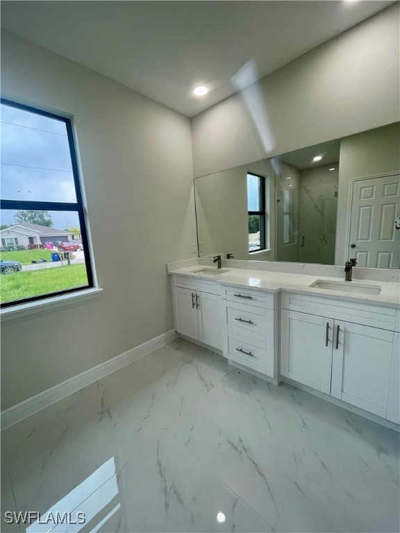 bathroom featuring a healthy amount of sunlight, vanity, and an enclosed shower