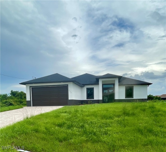 view of front of property with a front lawn and a garage