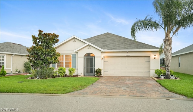 ranch-style home with a front yard and a garage