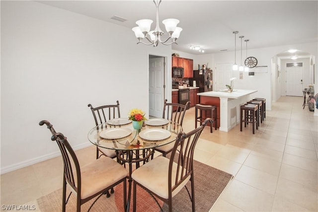 dining area featuring light tile patterned flooring and a chandelier