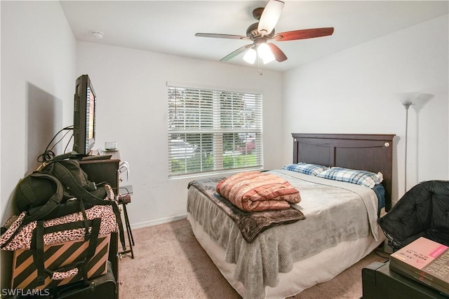 bedroom featuring light colored carpet and ceiling fan