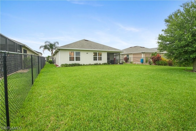 back of property featuring a lawn