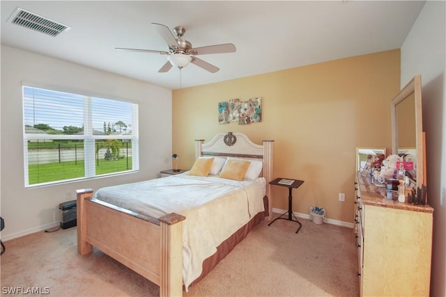 bedroom featuring ceiling fan and light carpet