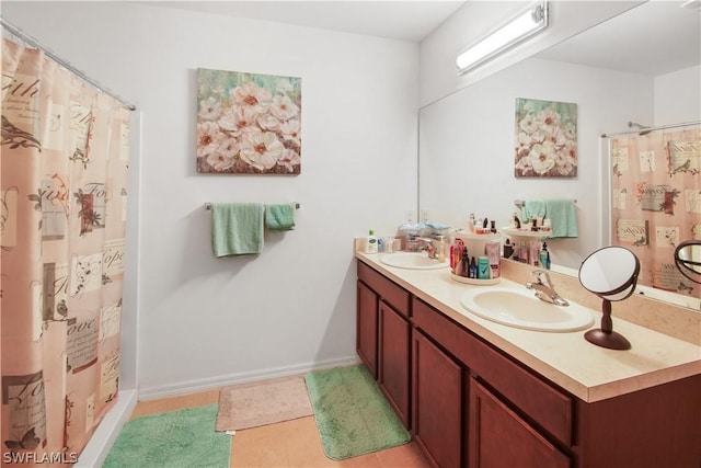 bathroom with vanity, tile patterned floors, and curtained shower