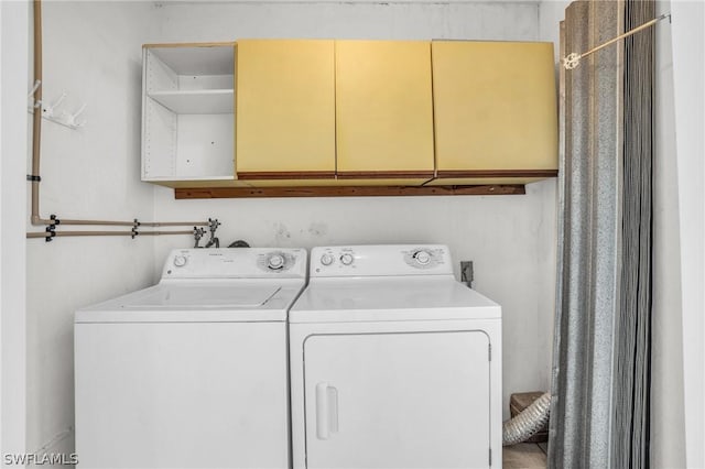 laundry area with cabinets and independent washer and dryer