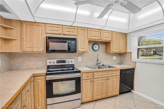 kitchen featuring tile countertops, black appliances, sink, decorative backsplash, and light tile patterned floors