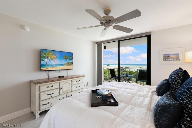 bedroom featuring ceiling fan, floor to ceiling windows, and access to outside