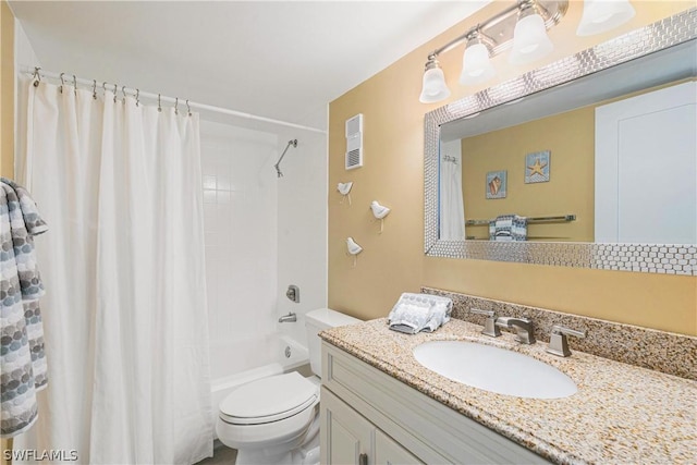 full bathroom featuring toilet, vanity, and shower / bath combo with shower curtain