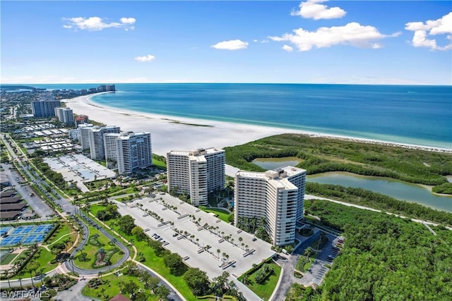 bird's eye view with a water view and a beach view