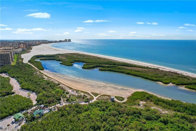 drone / aerial view featuring a water view and a view of the beach