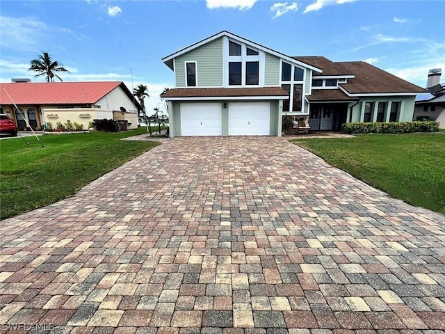 view of front facade with a garage, decorative driveway, and a front yard