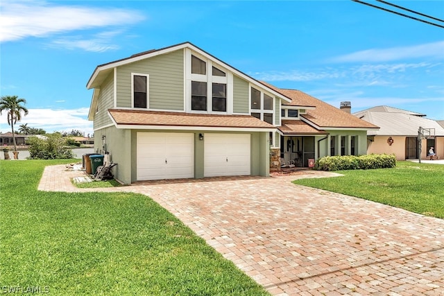 view of front of house featuring an attached garage, a shingled roof, decorative driveway, and a front yard