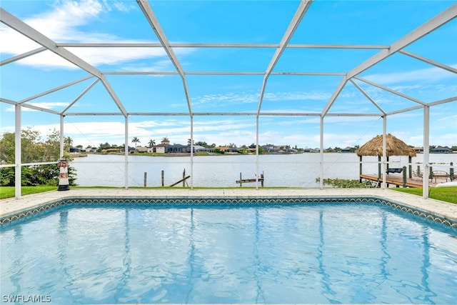 pool with a lanai, a water view, and a patio