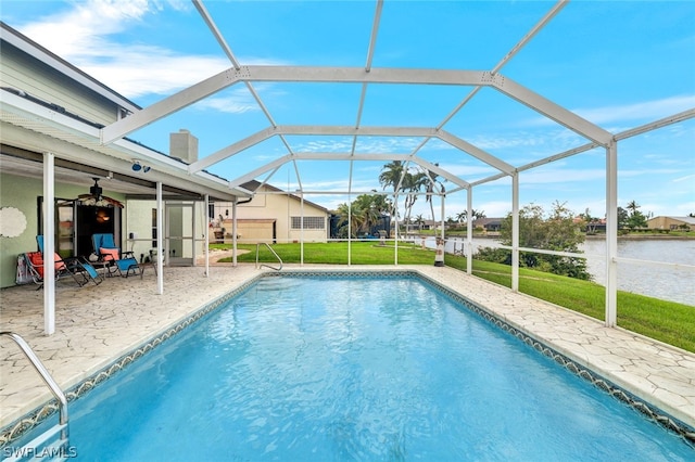 outdoor pool featuring a yard, a patio area, a lanai, and a water view