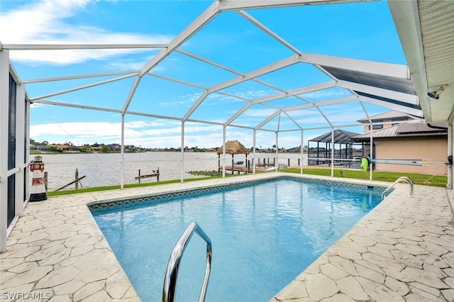 pool with a lanai, a water view, a lawn, and a patio