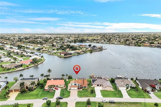 birds eye view of property with a water view and a residential view