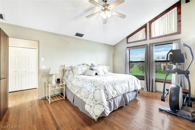 bedroom featuring wood-type flooring, visible vents, and vaulted ceiling