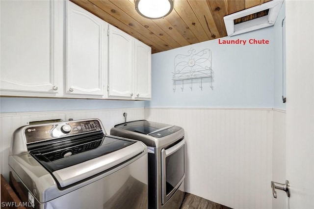 laundry room with cabinet space, washing machine and dryer, wood ceiling, wainscoting, and wood finished floors