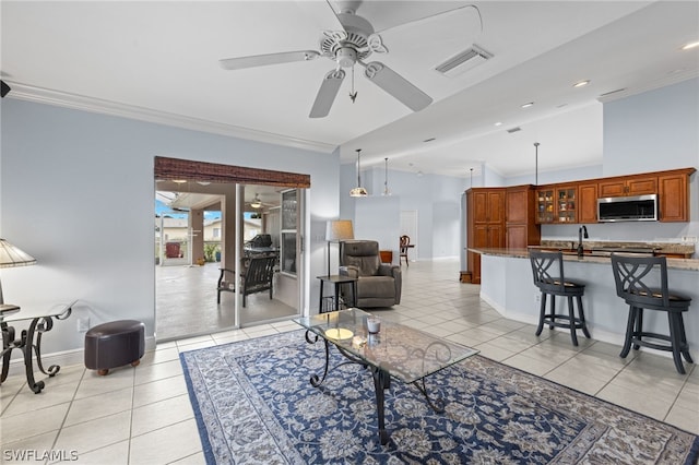 tiled living room featuring ornamental molding, sink, and ceiling fan