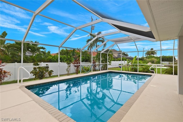 view of swimming pool with a patio and glass enclosure