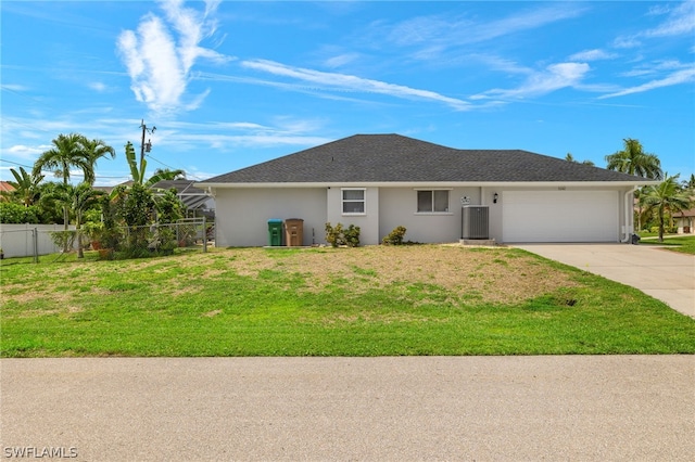 single story home with central AC unit, a garage, and a front yard