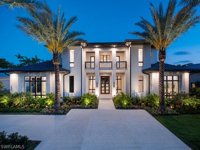 view of front of home with french doors and a balcony