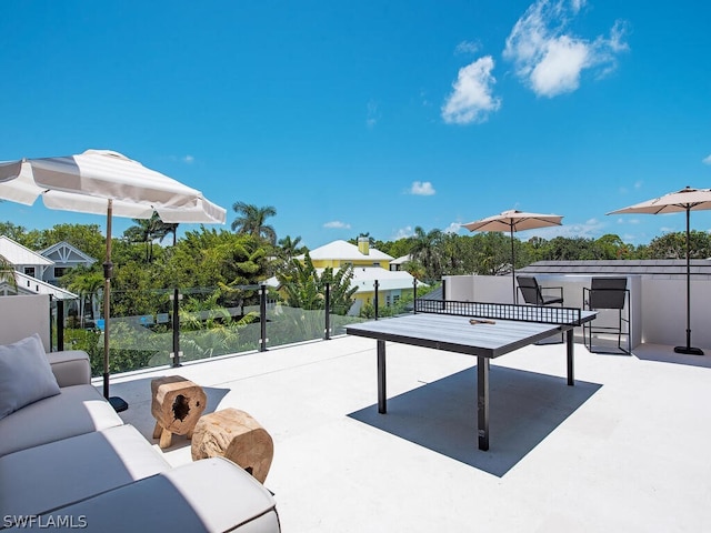 view of property's community with outdoor lounge area and a patio