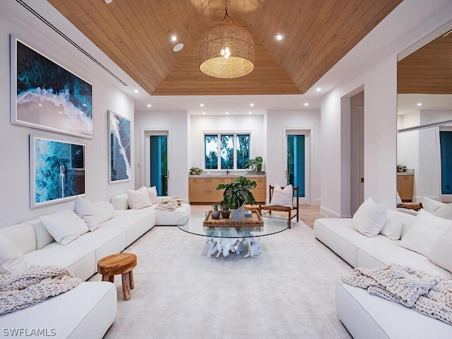 living room with a tray ceiling, wood ceiling, and vaulted ceiling