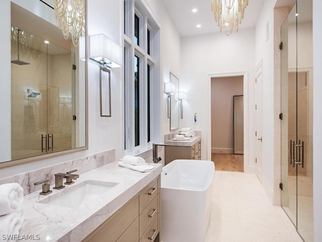 bathroom with a chandelier, vanity, and independent shower and bath