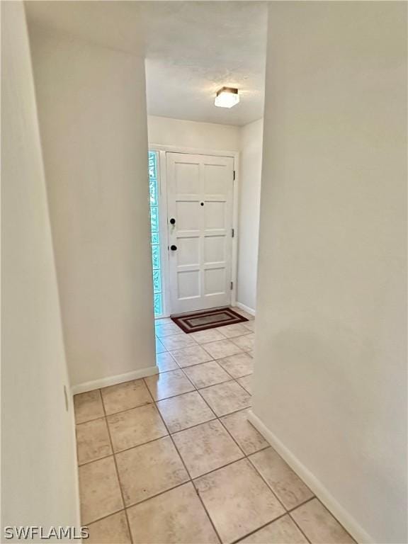 entryway with light tile patterned floors