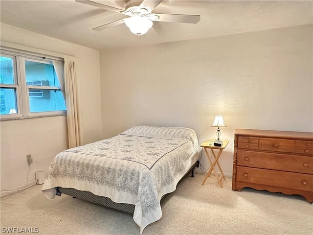 bedroom with light colored carpet and ceiling fan