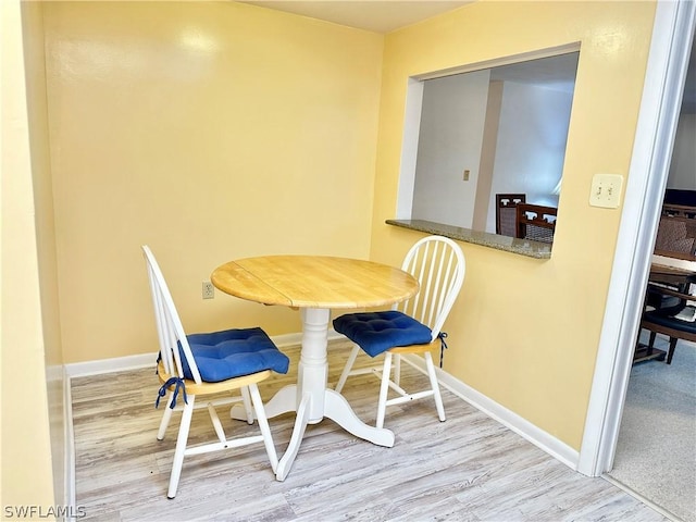 dining area featuring wood-type flooring