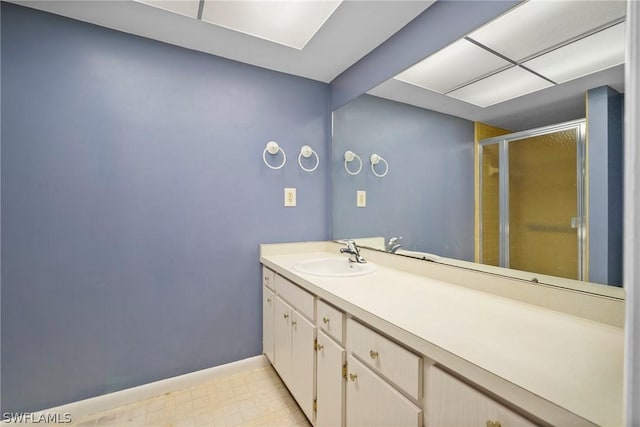 bathroom featuring vanity and a shower with door