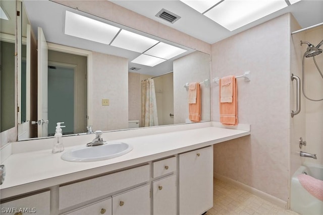 full bathroom featuring vanity, shower / bath combination with curtain, and toilet