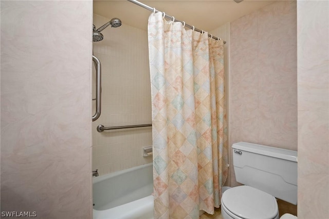 bathroom with toilet and shower / bath combo with shower curtain