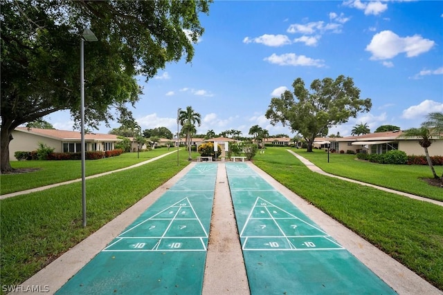 view of home's community with a yard