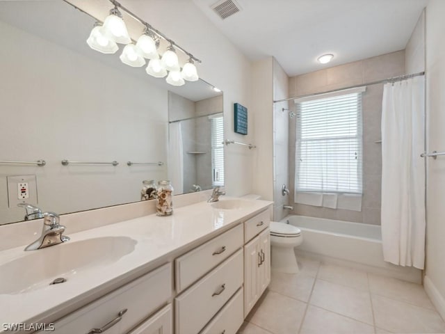 full bathroom with tile patterned flooring, vanity, toilet, and shower / bath combo with shower curtain