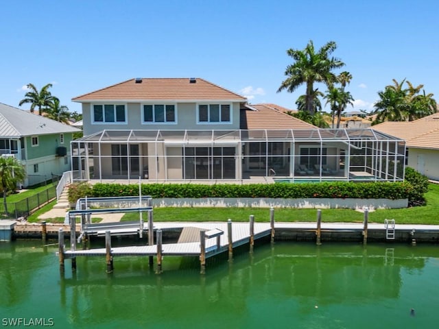 back of house featuring a lanai and a water view