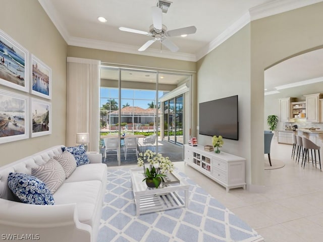 living room featuring ceiling fan, crown molding, and light tile patterned floors