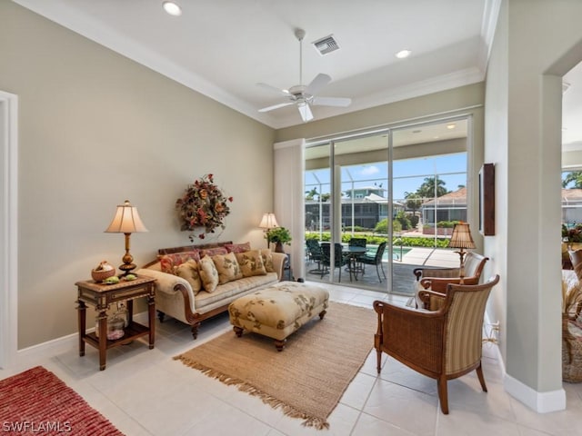 tiled living room featuring ceiling fan and ornamental molding