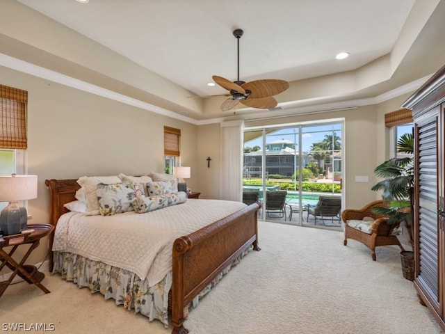 bedroom featuring access to exterior, ceiling fan, a raised ceiling, light colored carpet, and ornamental molding