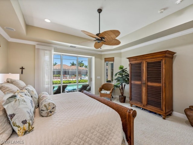 bedroom with a raised ceiling, ceiling fan, access to exterior, and light carpet