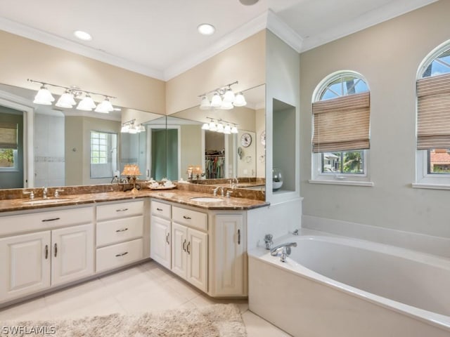 bathroom with crown molding, tile patterned flooring, vanity, and a bath