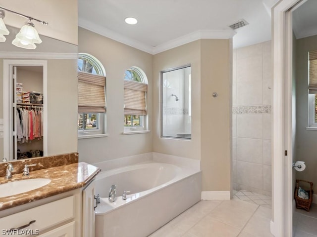 bathroom featuring tile patterned floors, crown molding, vanity, and shower with separate bathtub