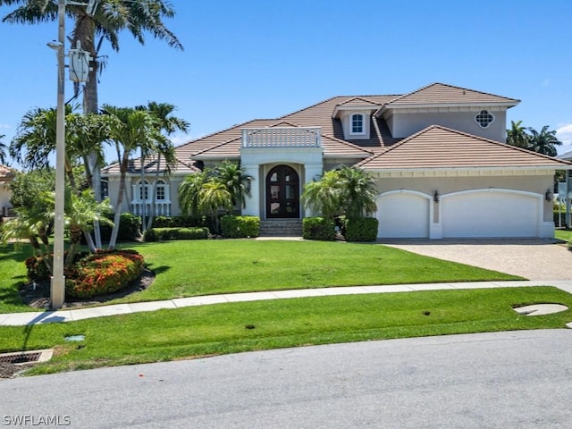 view of front of property featuring a garage and a front lawn