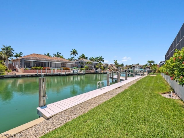 dock area featuring a lawn and a water view