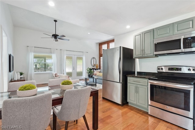 kitchen with appliances with stainless steel finishes, light hardwood / wood-style flooring, ceiling fan, and french doors